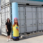 inflatable banner inflated. Woman stands beside as a size comparison