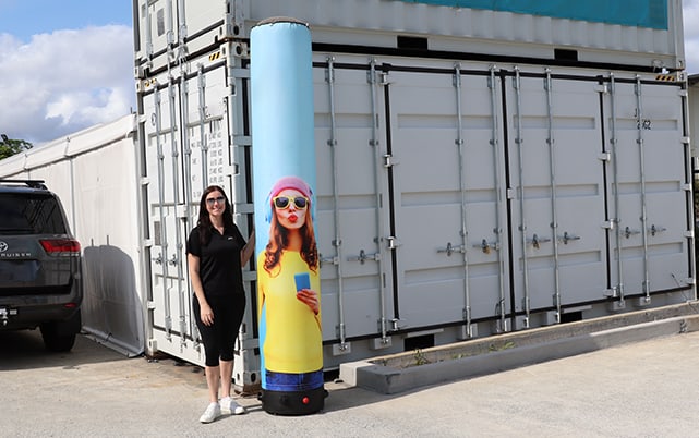 inflatable banner inflated. Woman stands beside as a size comparison